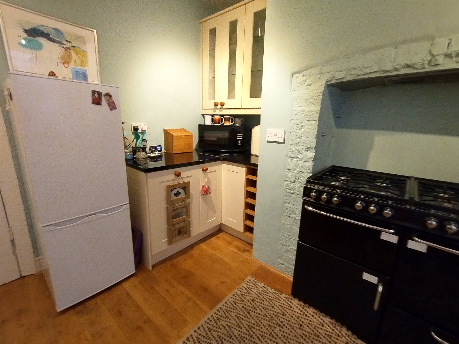 The cottage's kitchen, with cooker, fridge and microwave
